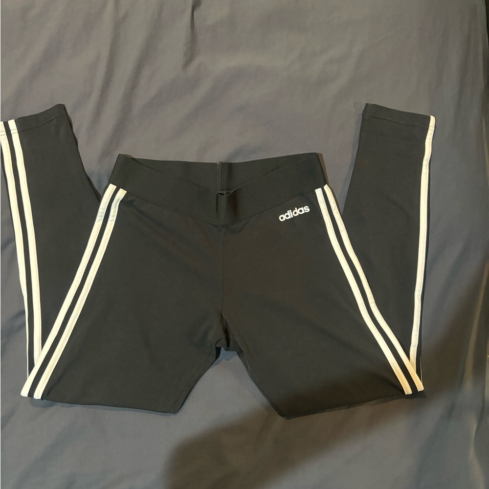Adidas black leggings with white stripes on the side and white logo.